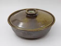 Large casserole dish by Barry Brickell, stoneware with brown and olive ash glaze to lid and interior, oversaturated iron glaze to the exterior, sold Feb 2026