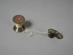Cotton Reel by Greer Twiss, cast bronze and twine, two parts, 1972, sold Feb 2026