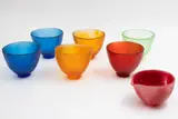 Dinosaur Designs, Set of six tea bowls and pouring jug, coloured resin