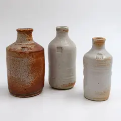 Three stoneware bottles by Len Castle, shino glazed stoneware, sold May 2025