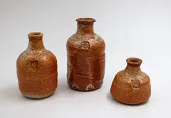Three stoneware bottles by Len Castle, shino glazed stoneware, sold May 2025