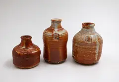 Three stoneware bottles by Len Castle, shino glazed stoneware, sold May 2025