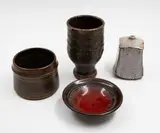 Collection of four small stoneware pieces by New Zealand Studio Pottery, comprising a dish by Ian Firth, a bowl by Barry Ball, a shino glaze vase and a cup, offered May 2025