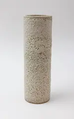 Volcanic cylinder vase by John Parker, light grey glazed ceramic with textured volcanic crater motifs, sold May 2025