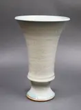 Graeme Storm, Stoneware trumpet vase, of flared form on pedestal base, with pale blue rutile glaze with silver effects
