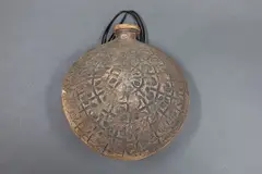 Hanging bottle by Len Castle, thinly potted stoneware with textured iron washed surface and impressed decoration (small flake chip), sold May 2025