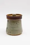 Small lidded pot by Chester Nealie, stoneware, the body with bluish grey glaze, the top rim unglazed, offered May 2025