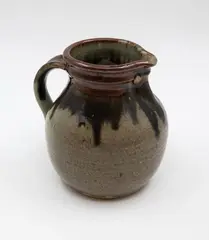 Small Fatso jug by Barry Brickell, stoneware with poured persimmon and dark grey glazes over an oatmeal crackle ground, sold May 2025