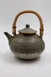 Teapot with cane handle by Len Castle, stoneware with mottled grey glaze, sold May 2025