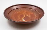 Shino glaze dish by Len Castle, stoneware with combed decoration, the glaze of deep orange tones, sold May 2025