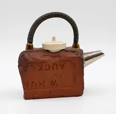 Peter Lange, 'Broken Brick' teapot, the earthenware body shaped as a broken brick, the handle as an iron rod and the lid as a bath plug (firing cracks)
