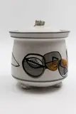 Hand-painted lidded jar by John Crawford, decorated with stylised fruit design, offered May 2025