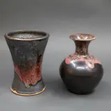 Two small stoneware vases by Graeme Storm, with manganese glaze with copper red highlights, offered May 2025