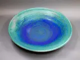 Graeme Storm, Wall charger, stoneware with mottled blue and green barium glaze, fitted with hanging wire