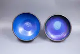 Two stoneware bowls by Graeme Storm, with rich blue barium glaze to the interior and manganese glaze to the rim and exterior, offered May 2025