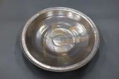 Large wall charger by Graeme Storm, stoneware, manganese glaze with gloss gold highlights (with hanging wire), offered May 2025