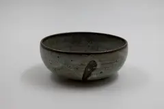Small bowl by Len Castle, stoneware with matt mottled grey glaze over iron glaze, sold May 2025