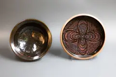 Stoneware bowl and dish by Graeme Storm, with wax resist designs on tenmoku glaze, offered May 2025