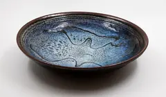 Shallow bowl by Len Castle, stoneware with jun mottled glaze over tenmoku glaze, wax resist gestural decoration, sold May 2025