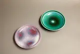 Graeme Storm, Two pin dishes, comprising a stoneware dish with gloss aqua green glaze, and a porcelain dish with purple and pale blue jun glaze