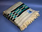 Roslyn Dunedin textiles, Early Manatunga travel rug, with a tukutuku panel pattern in ochre, green and brown