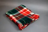 Kaiapoi Petone Group Textiles Ltd, Huia travel Rug, with a tartan design in green, red and white