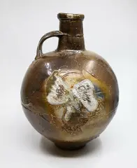 Large salt glazed wood fired flagon by Chester Nealie, partial textured finish with variable glaze effects in a gradation of browns and oranges, with large shell impressions t, sold Sep 2024
