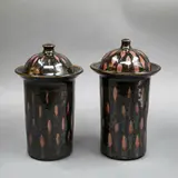 Graeme Storm, Pair of lidded jars, stoneware with tenmoku glaze with wax resist patch decoration