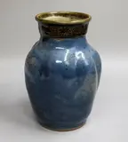 Barry Brickell, Stoneware vase, of baluster form, the blue glazed body with lobed shoulders, the lustrous brown glazed neck decorated with a repeating stylized sun pattern