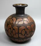 Graeme Storm, Stoneware spherical vase, with sgraffito cut stylised floral decoration in lighter brown carved through a dark matt manganese glaze
