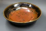 Len Castle, Large table bowl, stoneware with tenmoku glaze and wax resist gestural decoration to the centre