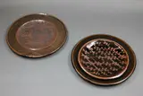Graeme Storm, Two stoneware dishes, with wax resist designs on tenmoku glaze