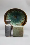Graeme Storm, Stoneware bowl, with wax resist flower decoration to the centre; together with a Graeme Storm small vase with manganese glaze; and another miniature vase
