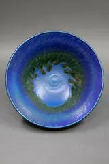 Stoneware bowl by Graeme Storm, with rich blue barium glaze and dark green highlights, sold Sep 2024