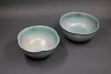 Graeme Storm, Pair of lobed rim bowls, porcelain with pale blue rutile glaze with silver effects