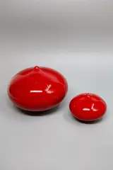Two red orb vases by Graham Ambrose, impressed potter's mark to the bases, sold Sep 2024