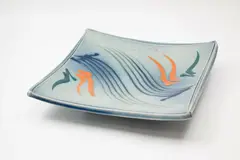 Merilyn Wiseman, Large slab square platter, raised on four lug feet, with Mashiko-rock abstract decoration in blue, green and orange on a soft blue ground
