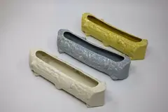 Temuka Pottery, Three trough vases, shaped as wooden logs, in pale blue, yellow and white glazes