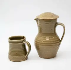 St Ives Pottery, Lidded jug and mug, with celadon glaze, impressed oak leaf design to the lid