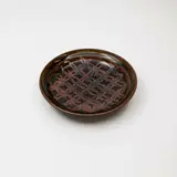 Graeme Storm, Stoneware dish, decorated with a tenmoku 'flower of life' wax resist design over dark olive glaze