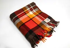 Kaiapoi Petone Group Textiles Ltd, Early Huia travel Rug, with a tartan design in bright red, orange, brown, black and white