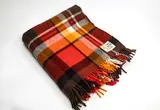 Kaiapoi Petone Group Textiles Ltd, Early Huia travel Rug, with a tartan design in bright red, orange, brown, black and white
