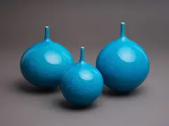 Three orb vases by Peter Collis, with spire neck and crackled bright turquoise glaze (AF), sold May 2024