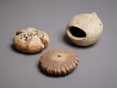 Three small stoneware items by Len Castle, including two sedge grass holders and a salt pourer, sold May 2024