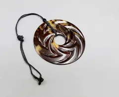 Steve Myhre, Large faux turtle shell pendant, cord necklace, faux tortoise shell pendant of round shape decorated with whirling chevrons