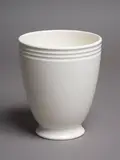 Ernest Shufflebotham for Crown Lynn, Hand-potted flared footed vase, with three concentric bands to the rim, white cream glaze, shape no. 18