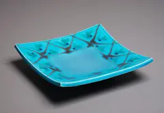 Large square ceramic platter by Merilyn Wiseman, in bright turquoise glaze with abstract orange and green decoration to the rim (small repair), sold May 2024