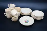 Early vitrified Paris Ware part tea service by Crown Lynn Potteries, comprising eight cream-coloured cups and saucers and six side dishes, another saucer with green painted rim, and a side , offered May 2024