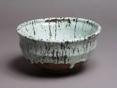 Large stoneware bowl by Len Castle, with a thickly poured duck-egg blue glaze with darker speckles from coarse inclusions in the body, sold May 2024