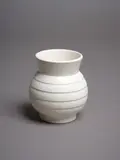 Ernest Shufflebotham for Crown Lynn, Small hand-potted vase, with white cream glaze, flaring neck and concentric bands to the body, shape no. 24